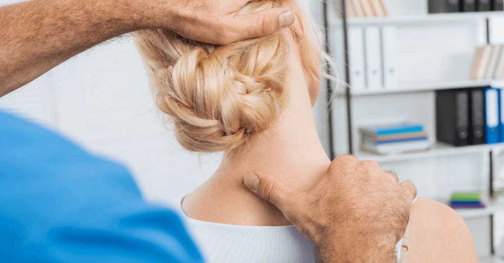 partial view of chiropractor stretching neck of woman during appointment